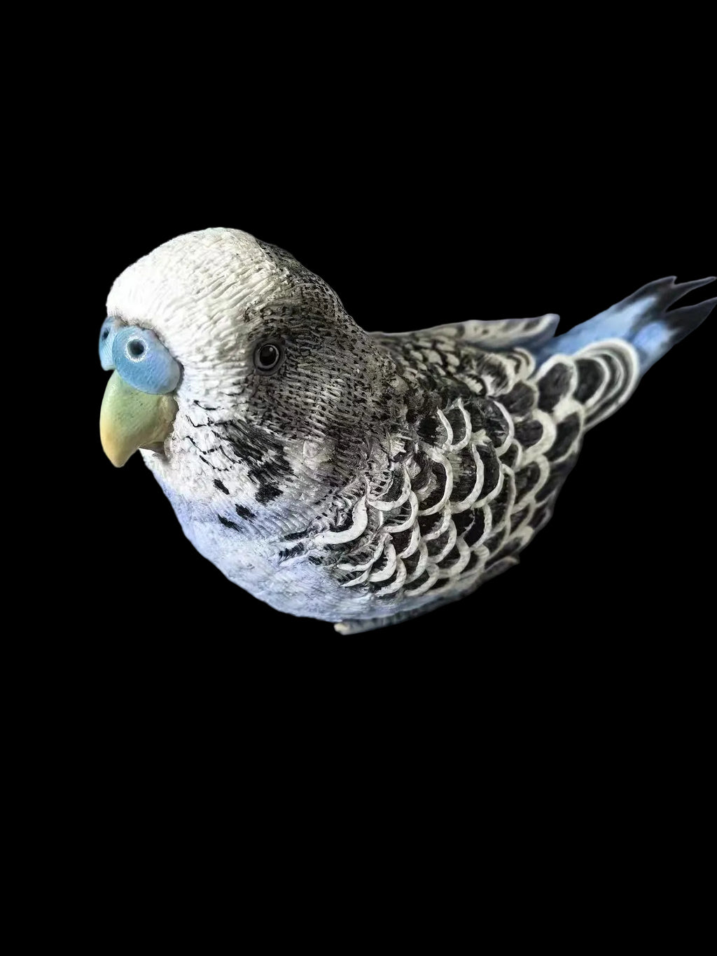 Close-up of the sculpting process for a textured gray pet figurine