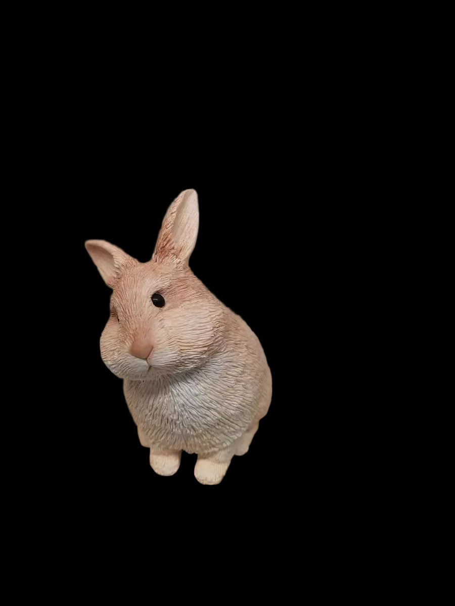 Front view of a custom hand-sculpted rabbit figurine displayed on a wooden base