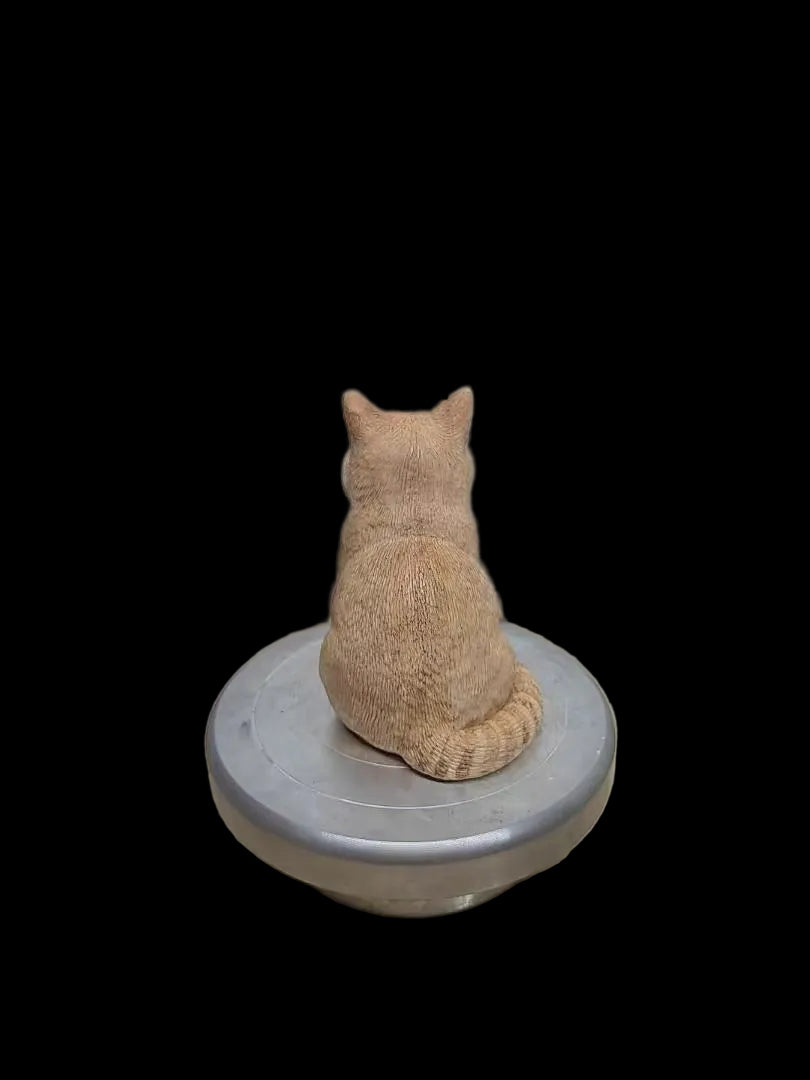 Back view of a custom orange cat figurine showing painted fur details and tail